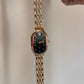 Oval black dial watch